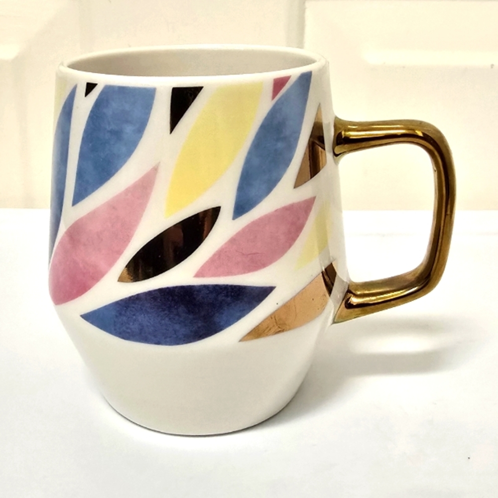 Multi colored leaves design 20 oz white ceramic mug with gold tone handle